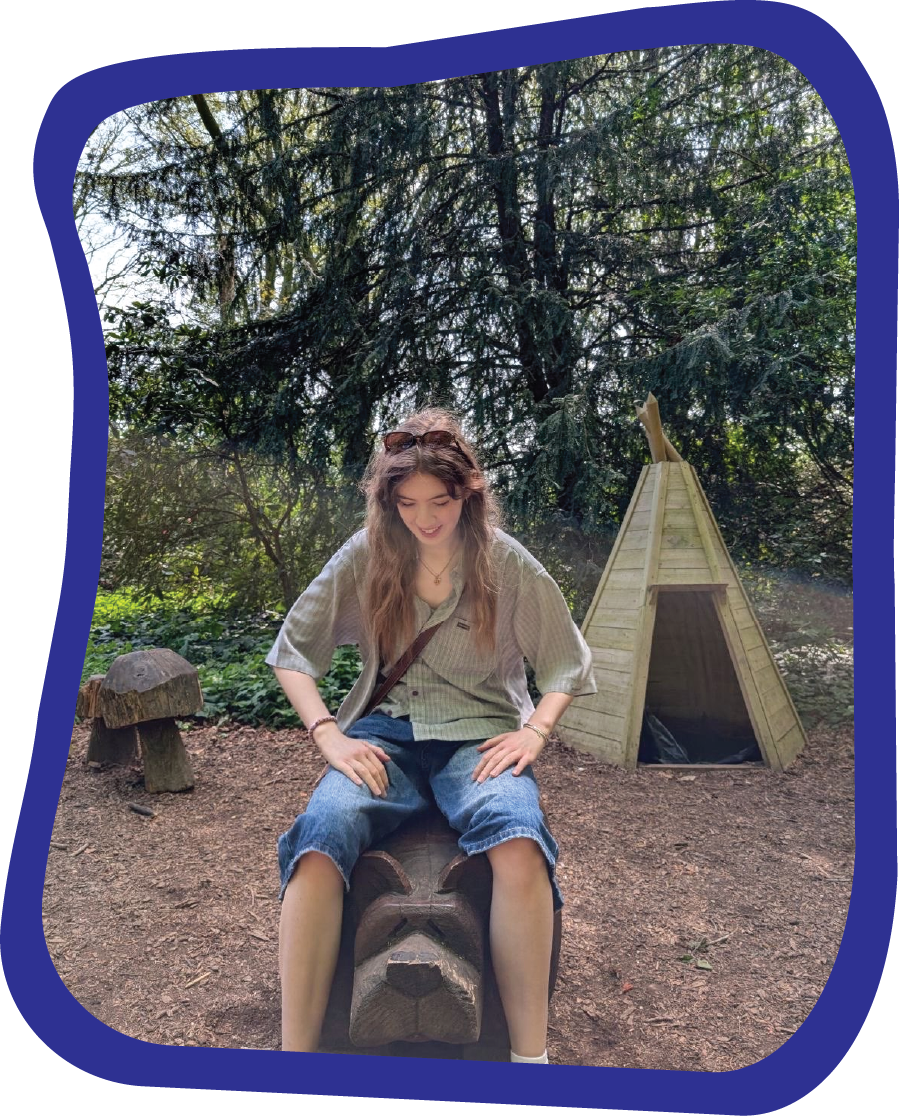 Beth sitting in a woodland setting