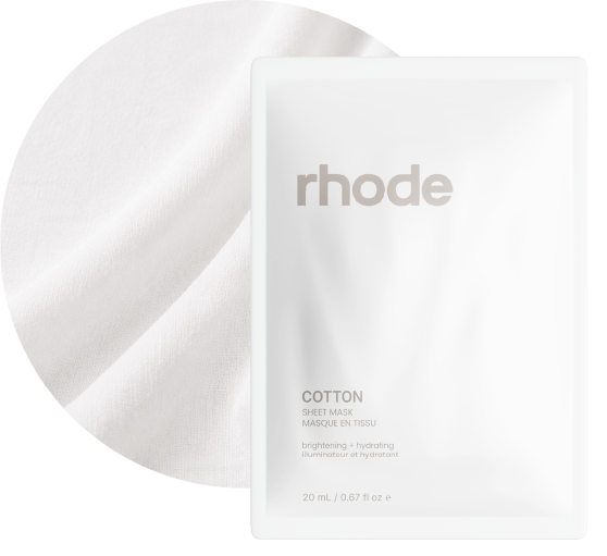Cotton sheet-mask packaging layered over white cotton fabric