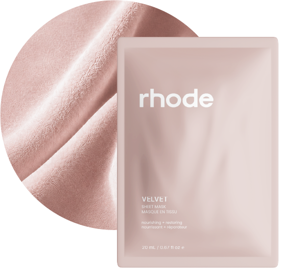 Velvet sheet-mask packaging layered over blush velvet fabric