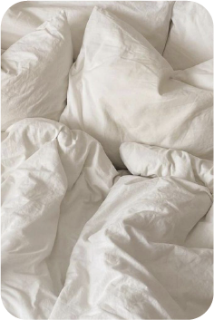 Soft white unmade bedding