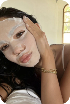 Woman relaxing while wearing a sheet mask
